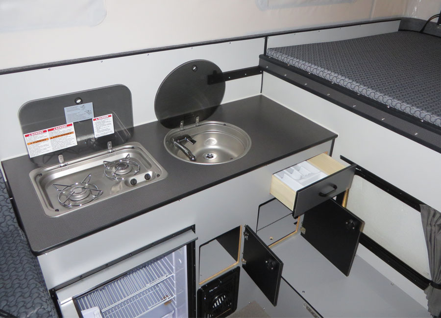 flush_mount_sink_stove_silver_spur_hawk_flat_bed_popup_camper.jpg